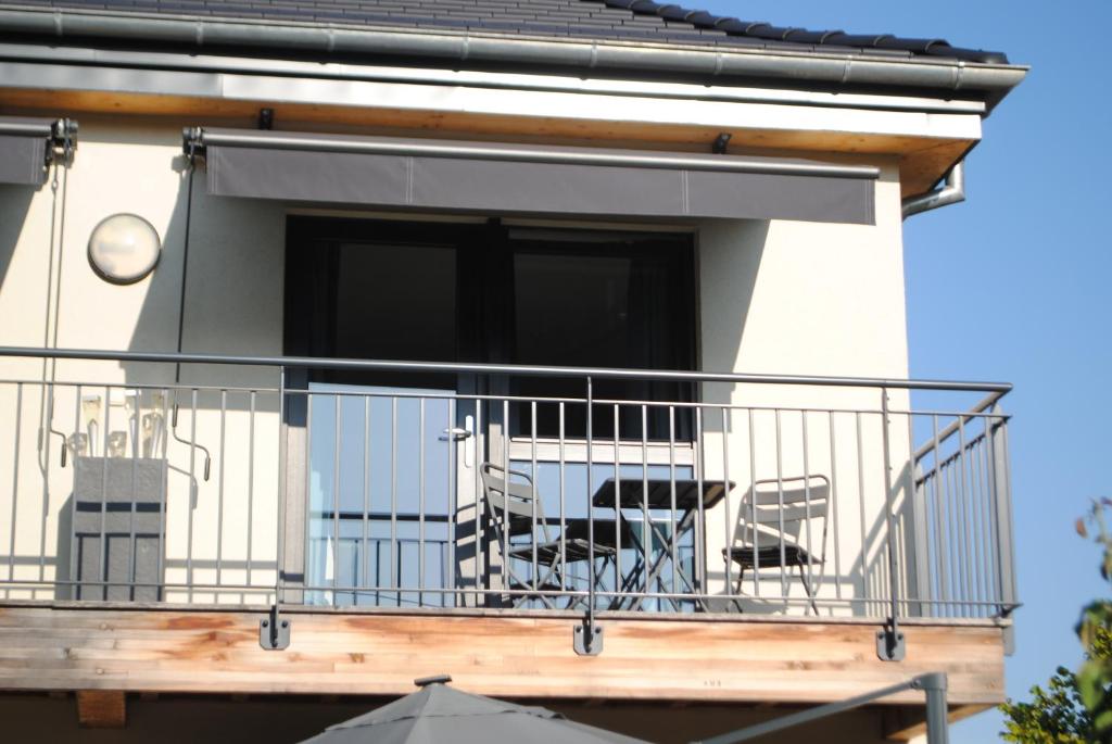 a balcony of a house with a table and chairs at Quiet Corner in Colmar