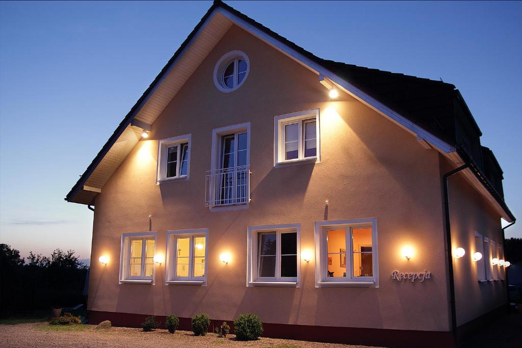 a house with lights on the side of it at Noclegi Agape in Szczecin-Płonia