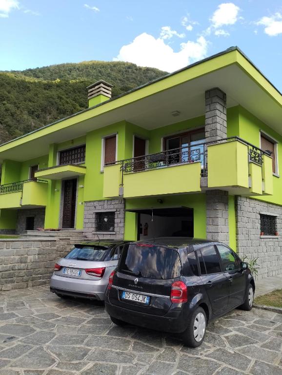 dwa samochody zaparkowane przed domem w obiekcie Il Faggio w mieście Beura