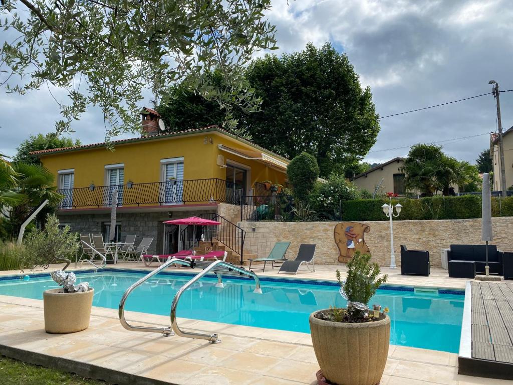 a house with a swimming pool in front of a house at VILLA ROMAGA in Vernet-les-Bains