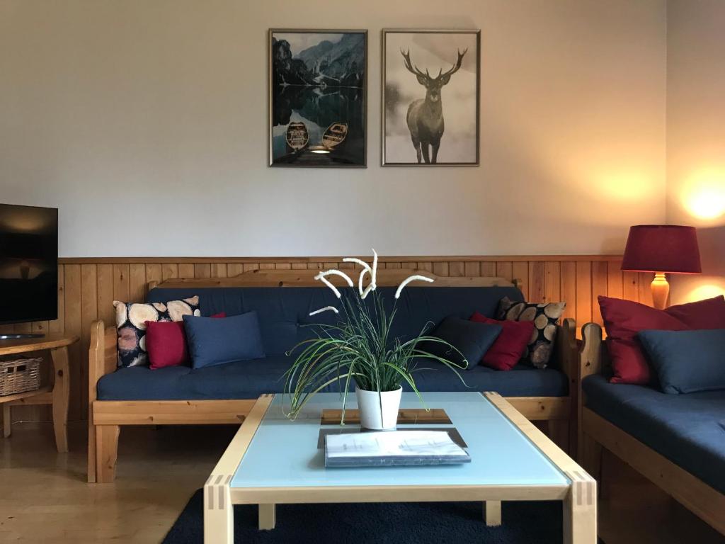 a living room with a blue couch and a table at Apartment Rentun Maja in Saariselka