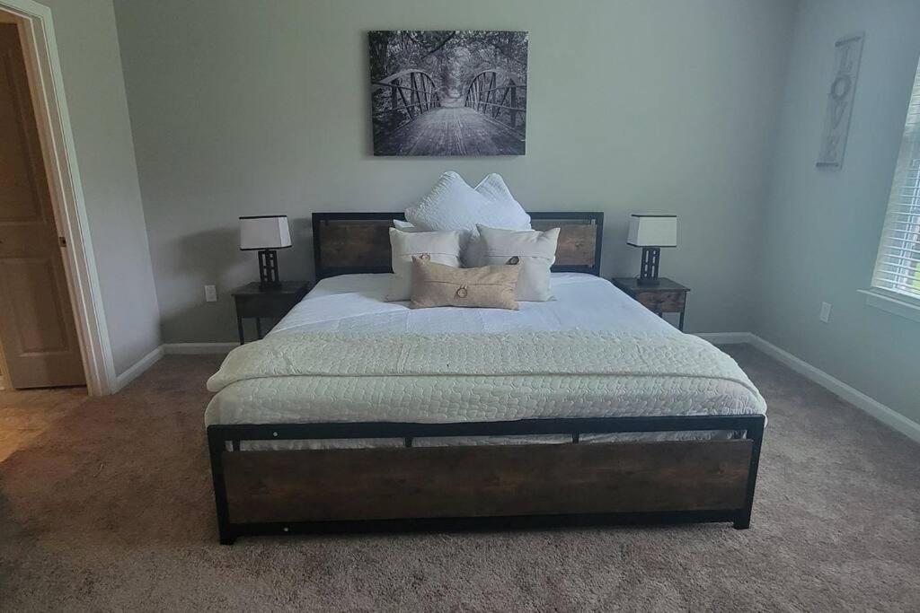 a bedroom with a large bed with pillows on it at Luxury 2 Bedroom 2 Bath and 1 Car Garage with Pool in Memphis