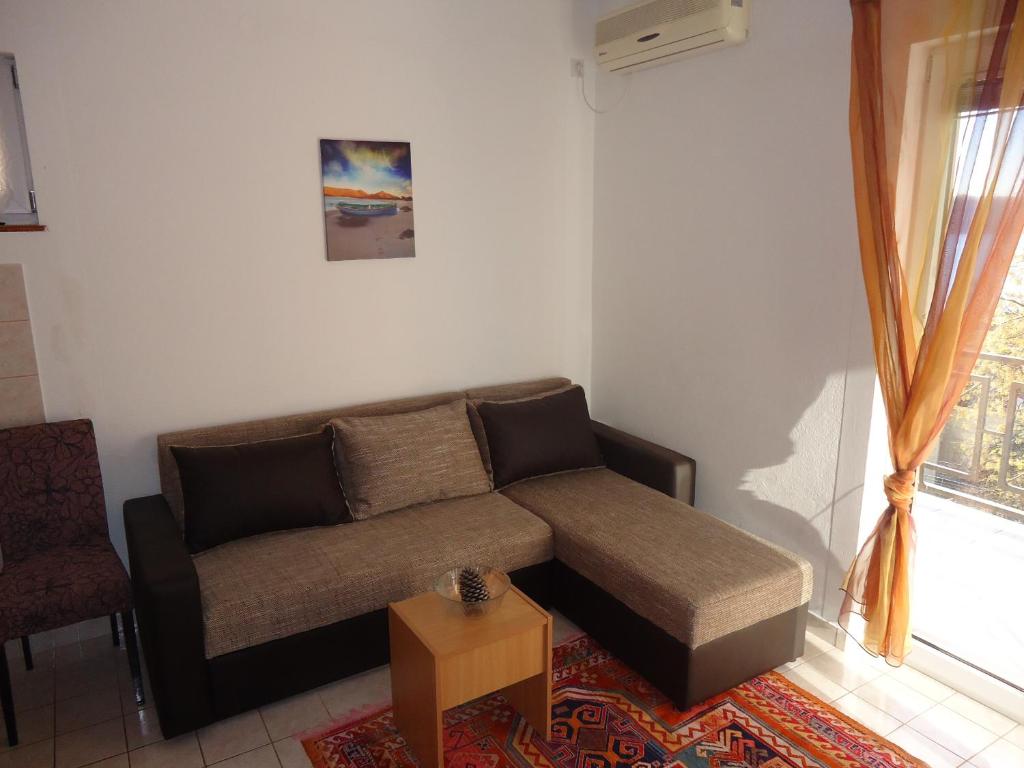 a living room with a couch and a table at Apartments Villa Mićunović in Herceg-Novi