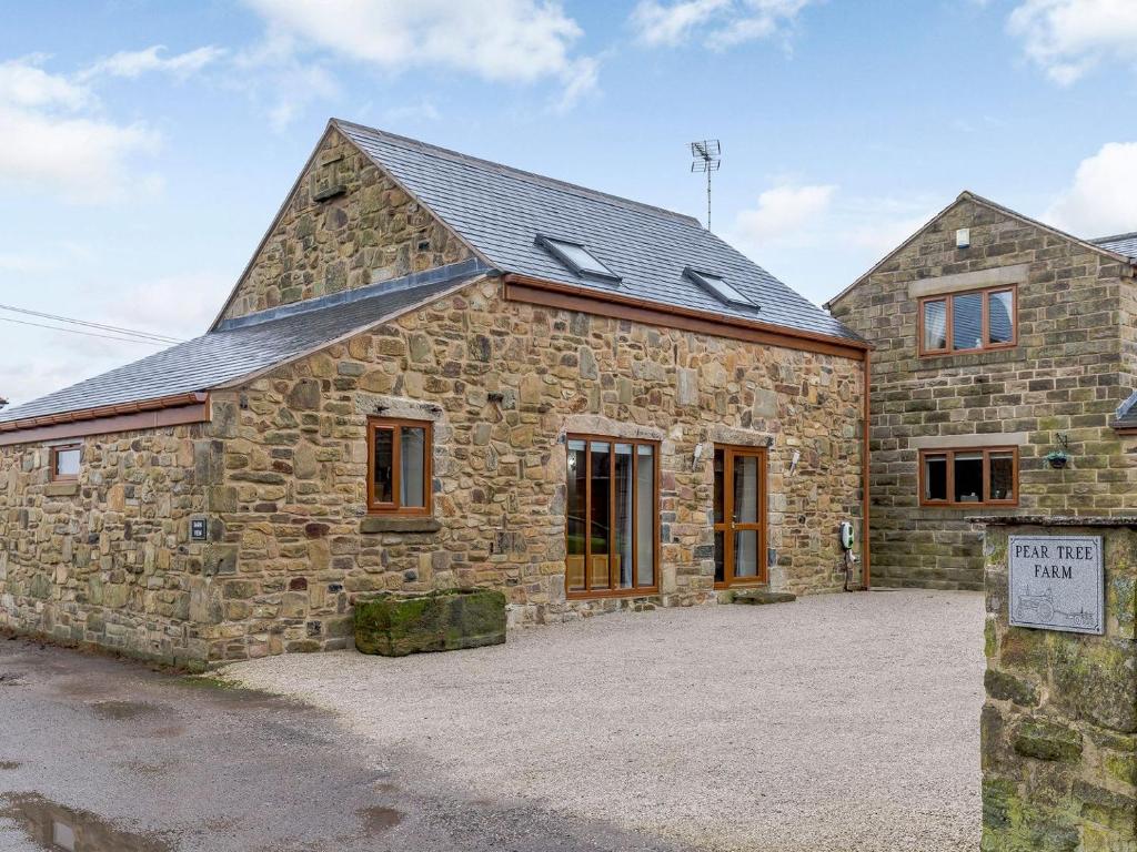 a stone building with a sign in front of it at Barn View in Clay Cross