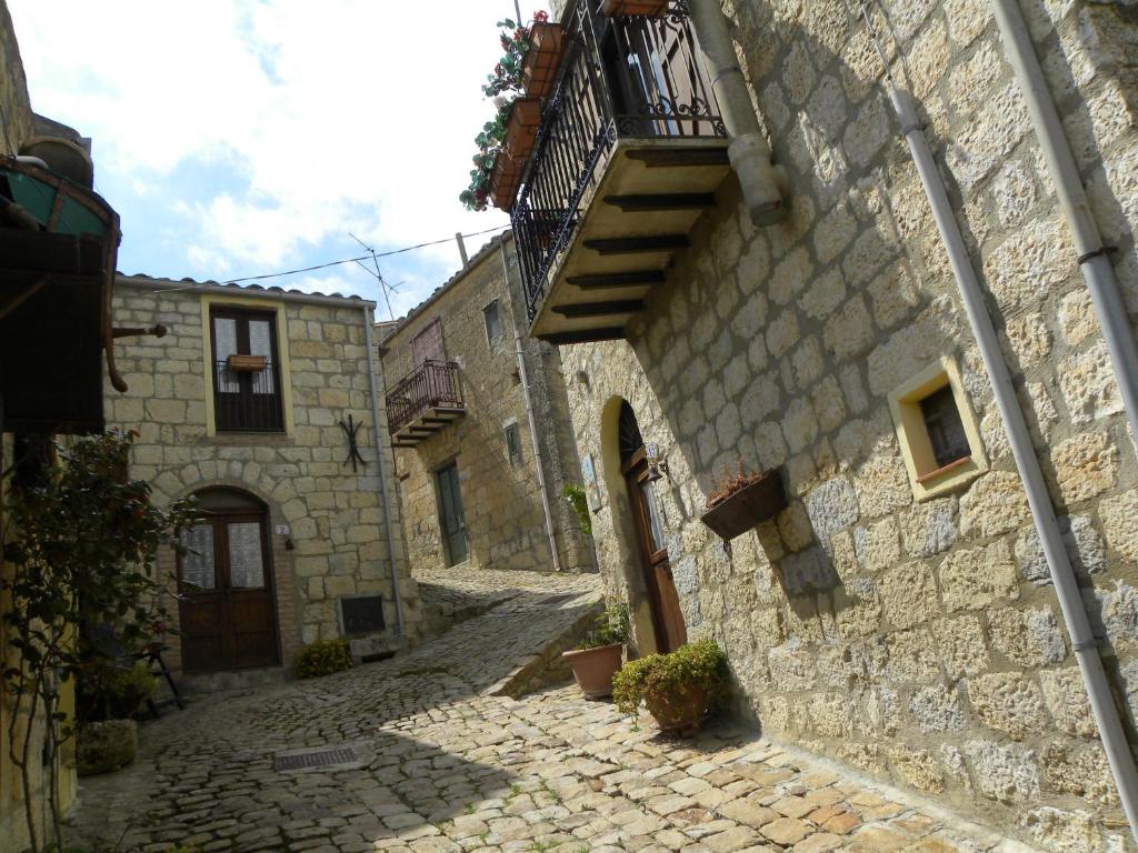 un callejón en un antiguo edificio de piedra con una escalera en Borgo i Stritti, en Petralia Soprana