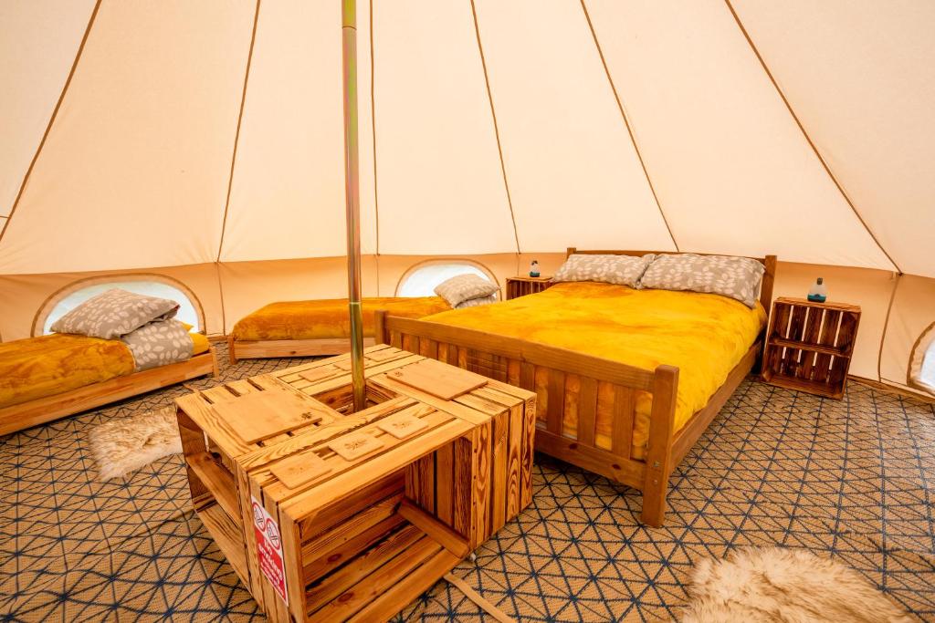 a room with two beds in a tent at Roaches Retreat Eco Glampsite - Hen Cloud View Bell Tent in Upper Hulme