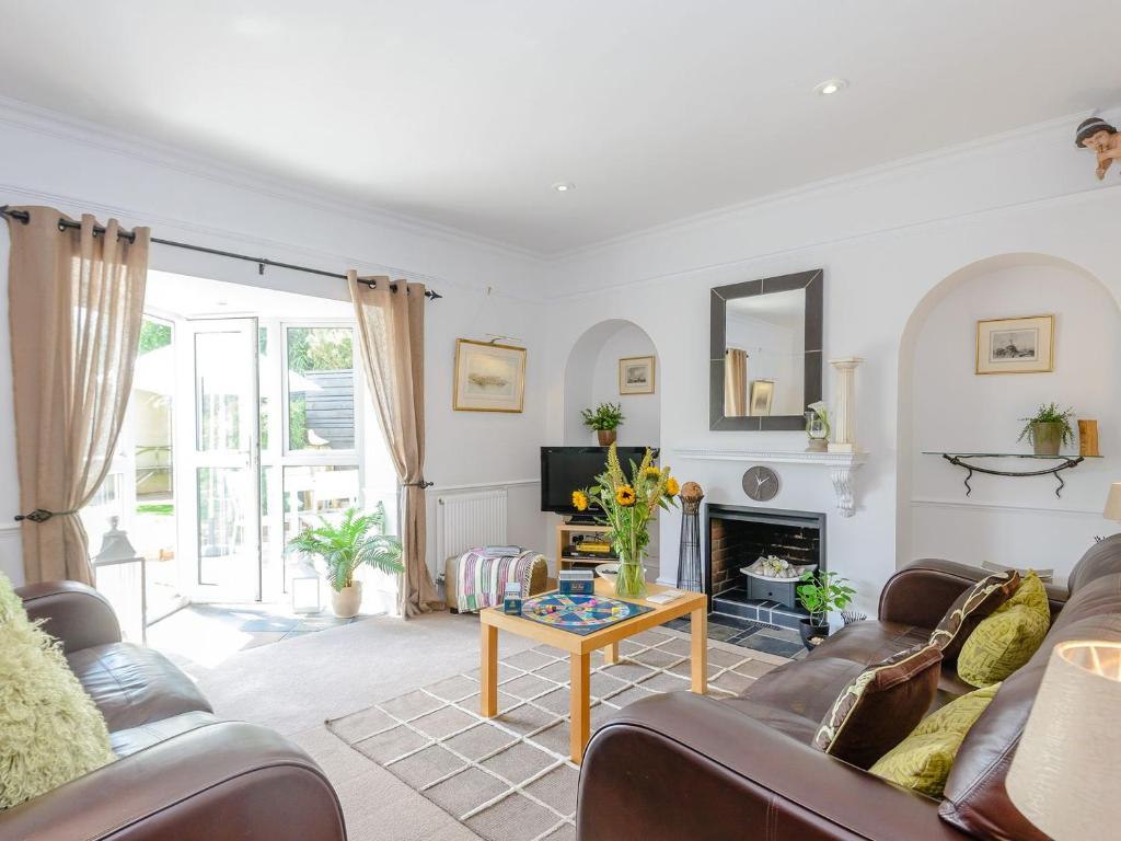 a living room with a couch and a fireplace at Number 1 Admiralty Cottages in Alverstoke