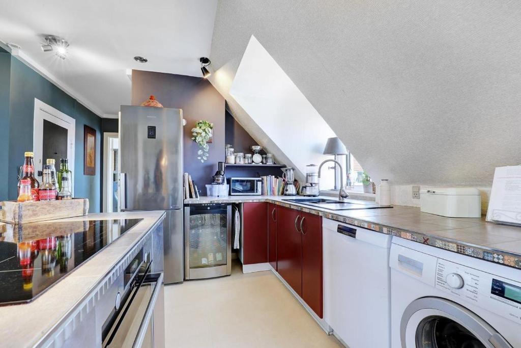 a large kitchen with a washer and dryer at Comfortable stay in Copenhagen, single room in Copenhagen