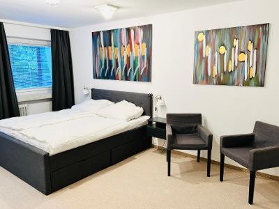 a bedroom with a bed and a table and a chair at Residenz Goslarsche Straße in Bad Harzburg