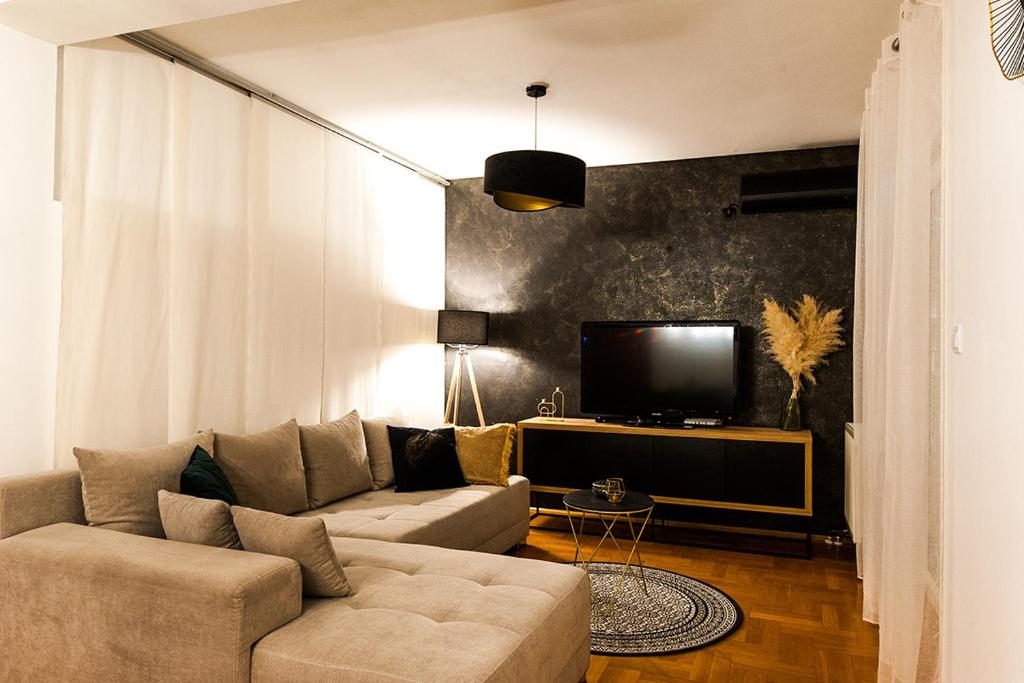 a living room with a couch and a tv at ARENA in Osijek