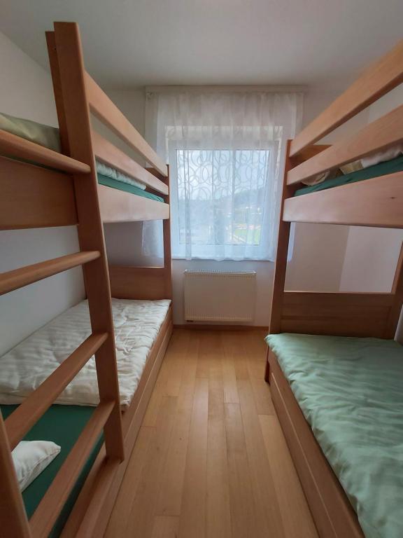 a room with three bunk beds and a window at Sara Sarajevo in Bjelašnica