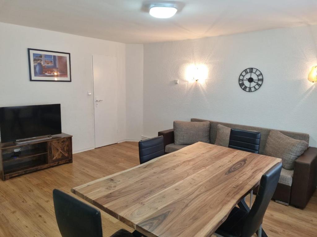 a living room with a wooden table and a couch at Ferienhaus Formidable in Nidderau