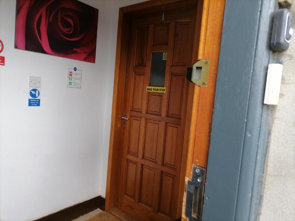 a wooden door in a room next to a wall at Impeccable 2-Bed Flat in Wick in Wick
