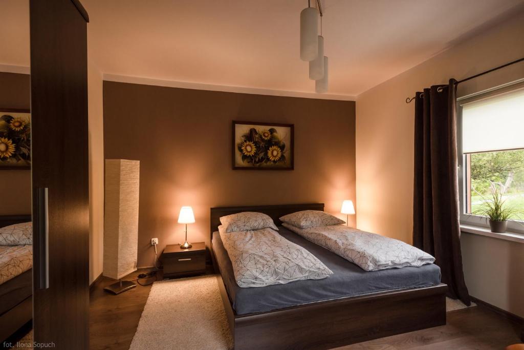 a bedroom with two beds and a window at Salamandra in Rajcza