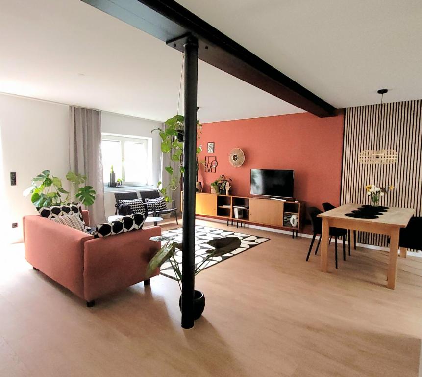 a living room with a couch and a table at Ferienwohnung Anna Maria Erding in Erding