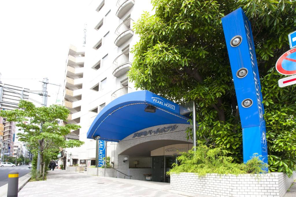 a blue sign on the side of a building at Pearl Hotel Kayabacho in Tokyo