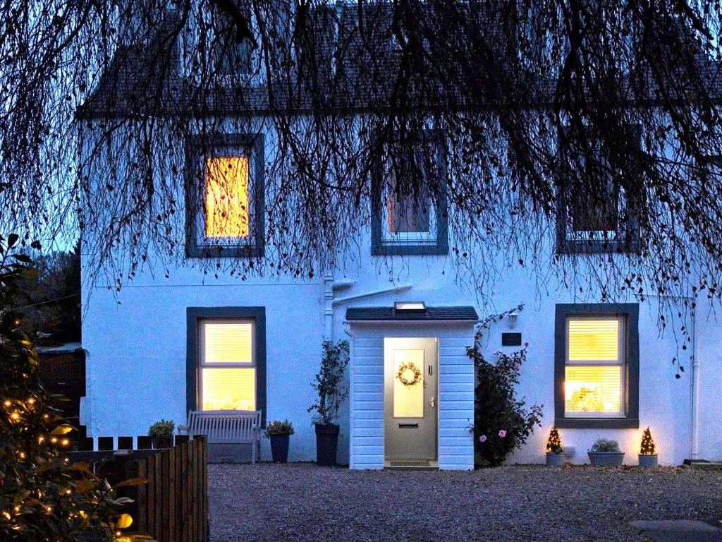 a white house with a door in front of it at Lower Canterbury House in Gattonside