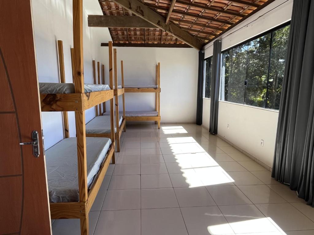 a room with several bunk beds and a window at Hostel Pipe House in Ilhéus