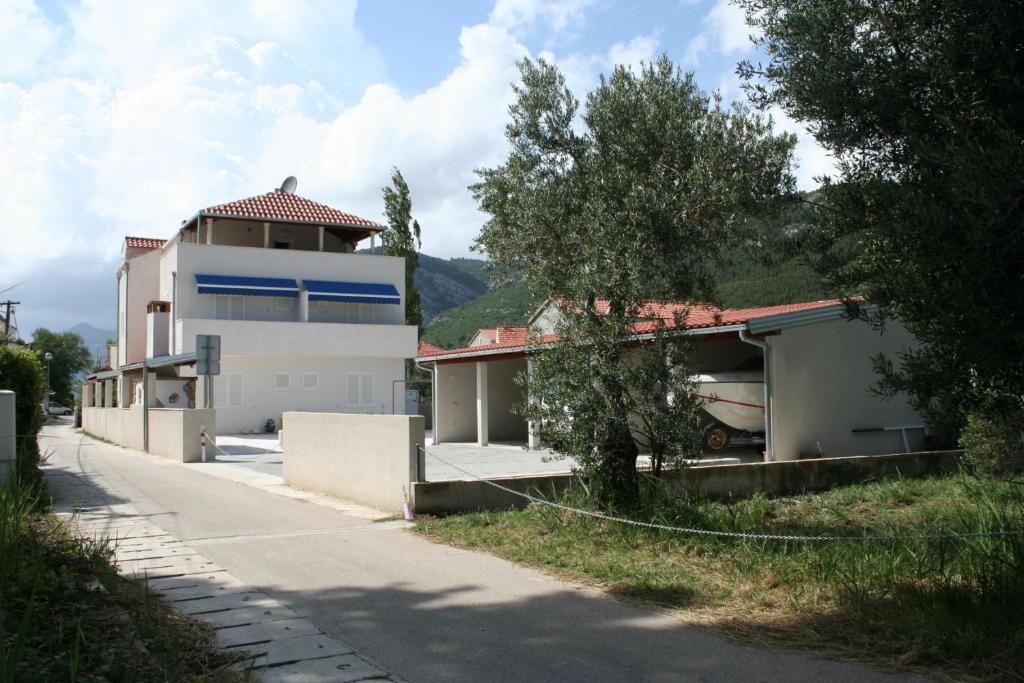 a house on the side of a road at Apartments and rooms by the sea Zuljana, Peljesac - 3164 in Žuljana