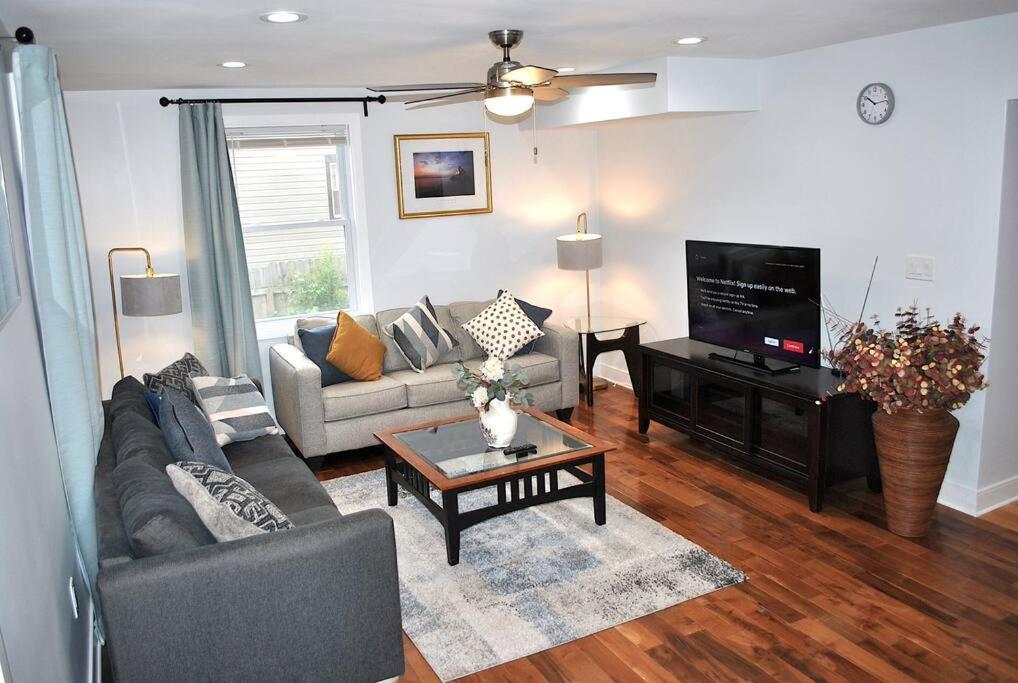 a living room with a couch and a tv at Stylish 4-Bedroom Full House. Plenty of Parking! in Catonsville