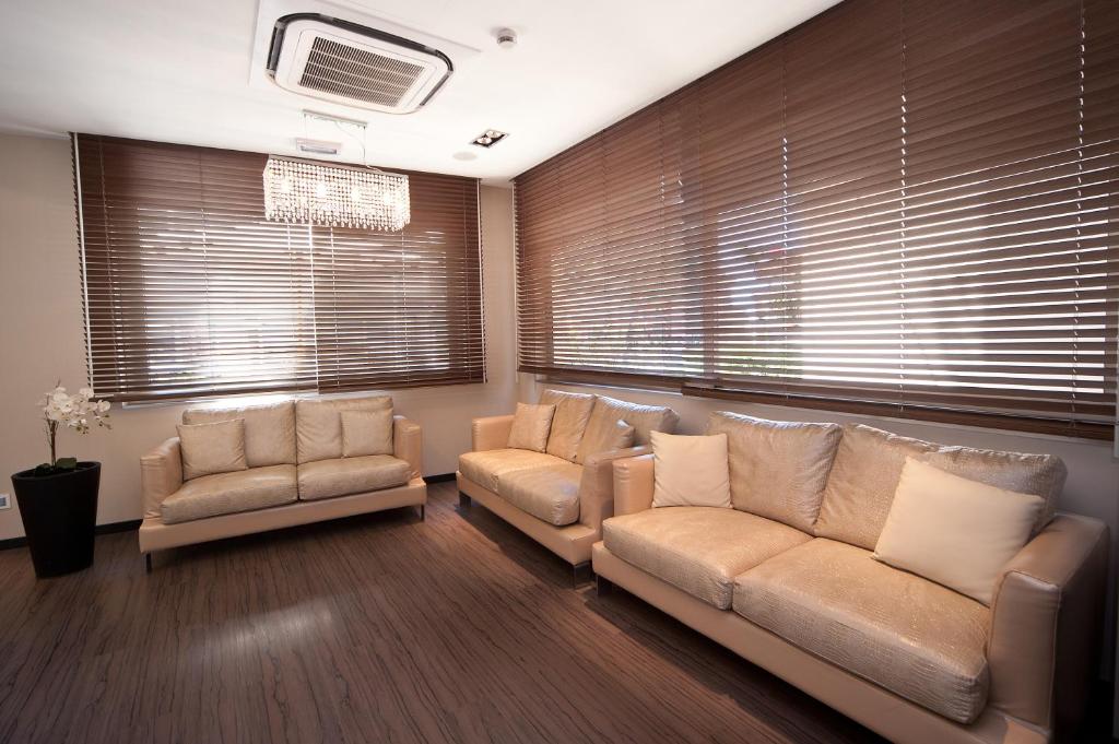 a living room with a couch and two chairs at Hotel Carla in Levanto