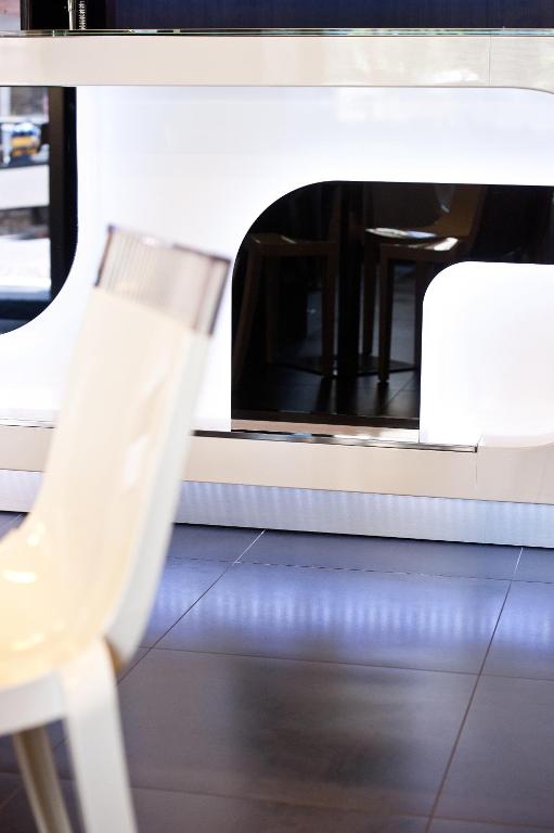 a white chair sitting in front of a oven at Hotel Carla in Levanto