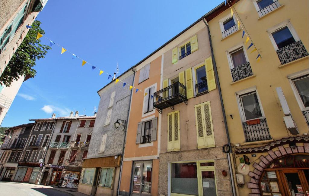 a row of buildings on a street with a string of flags at Amazing Apartment In Seyne With Kitchen in Seyne