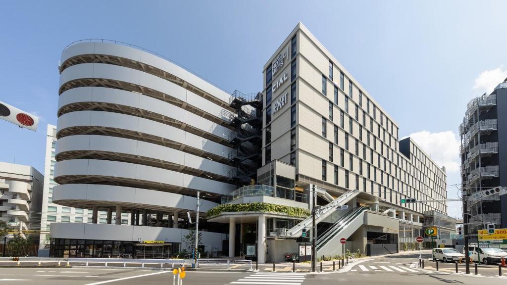 a building in a city with a street at JR-East Hotel Mets Yokohama in Yokohama