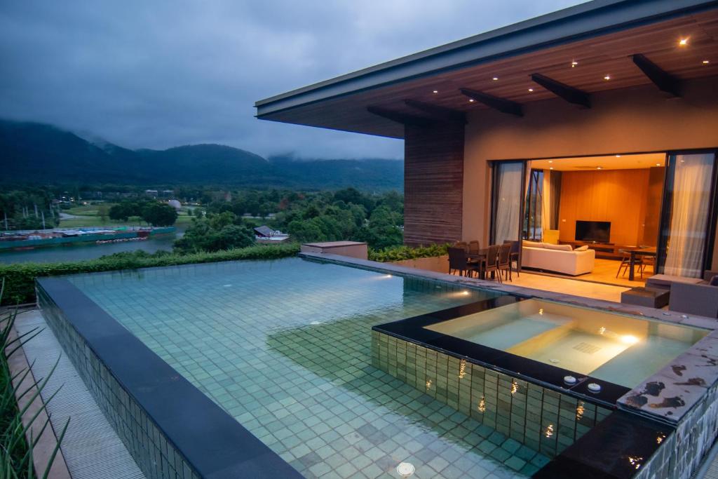 a villa with a swimming pool and a house at Khaoyai Luxury Pool Penthouse at ATTA in Pak Chong
