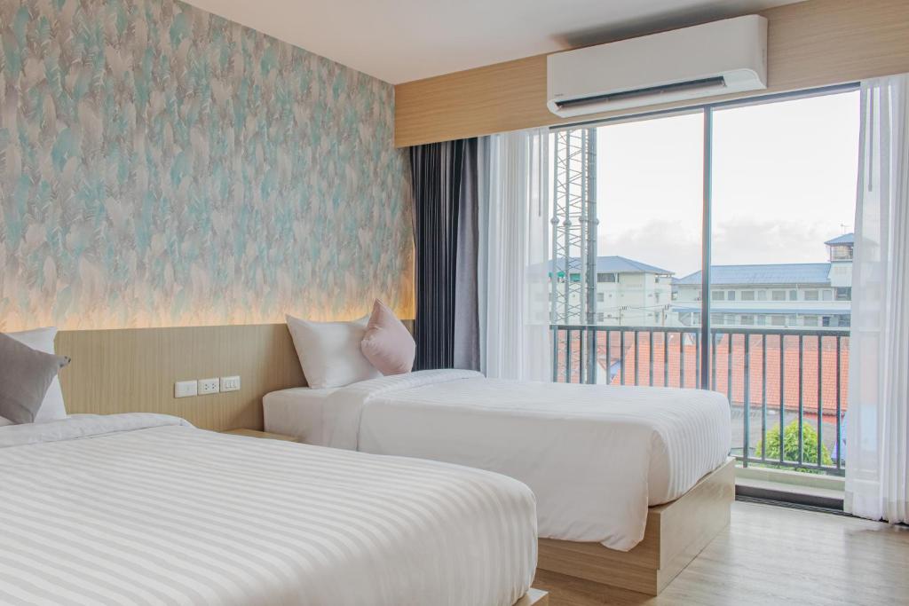 Postel nebo postele na pokoji v ubytování ONE Hotel
