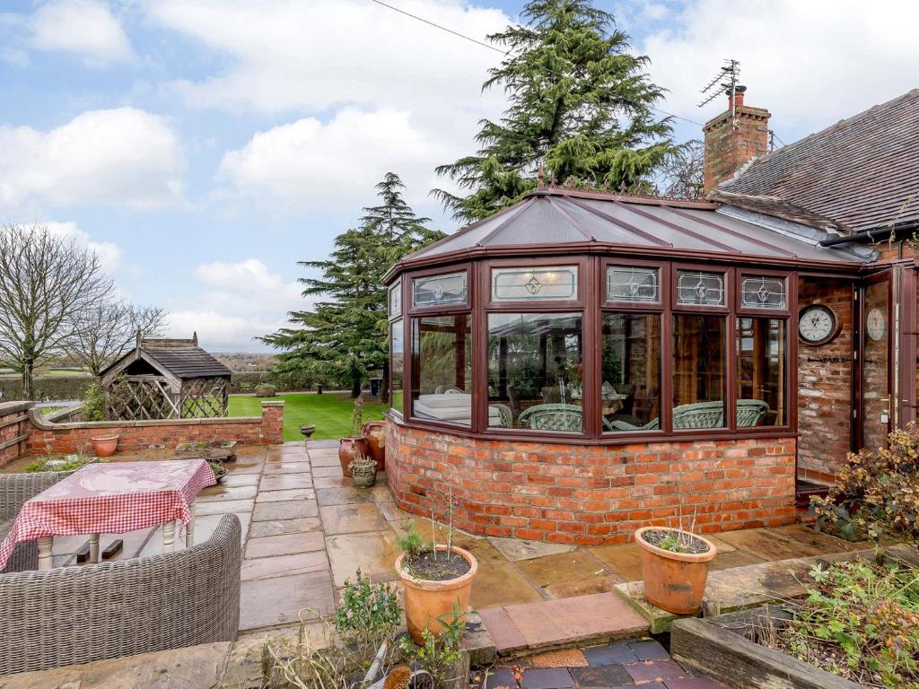 a greenhouse in the garden of a house at The Pigsty - Uk30945 in Barthomley