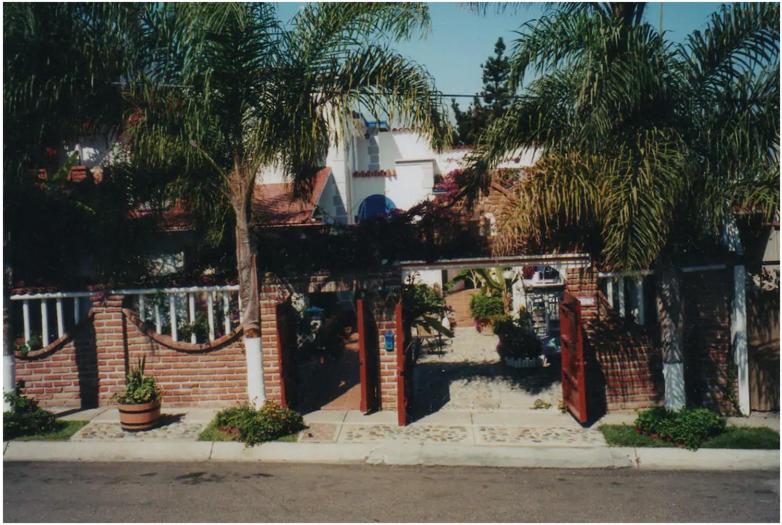 a brick house with a gate and palm trees at Welcome To Casa OLE Playas de Tijuana 5-Rooms 14-Guests close to Shoping Center & Beach in Tijuana