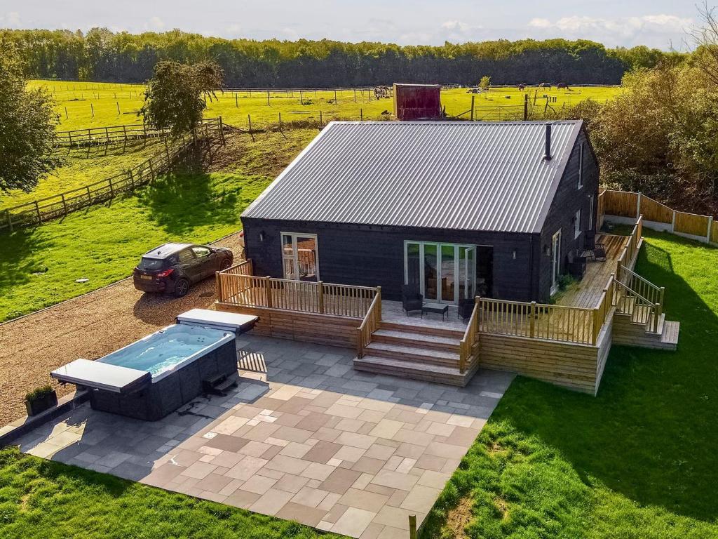 an aerial view of a small house with a pool at Deerson Barn in Wingham