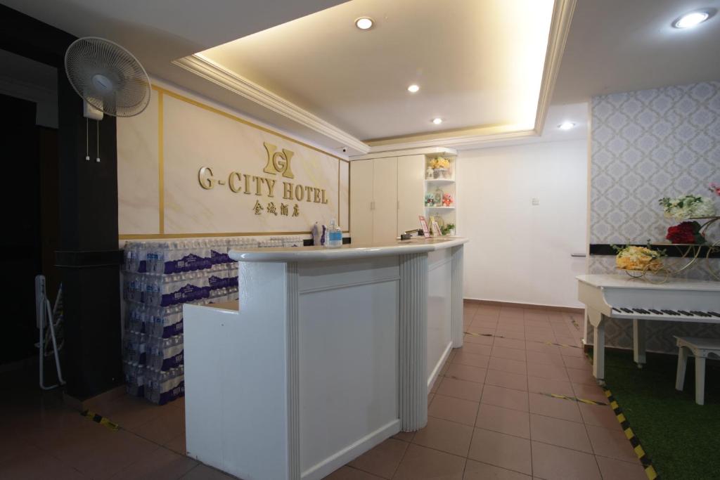 a kitchen with a counter in a room at G CITY HOTEL in Teluk Intan