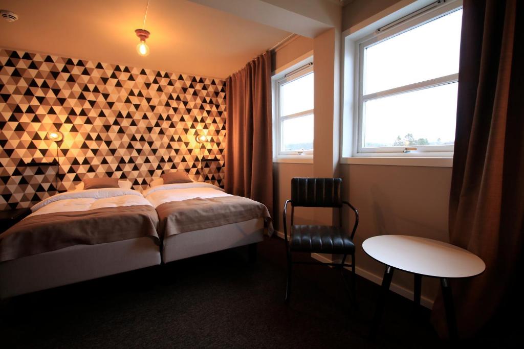 Postel nebo postele na pokoji v ubytování Bakkalandet Hotel