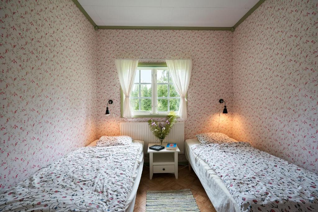 Postel nebo postele na pokoji v ubytování Savolax Stugor