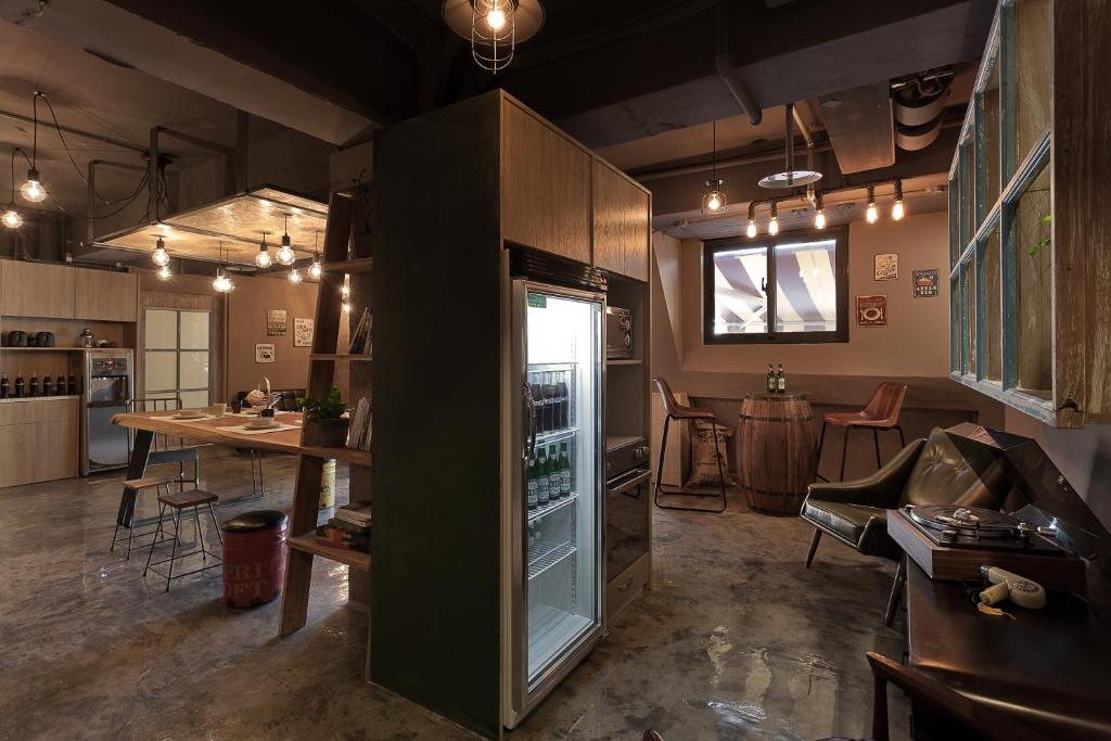 a room with a kitchen and a living room at Ximen Wow Hostel in Taipei