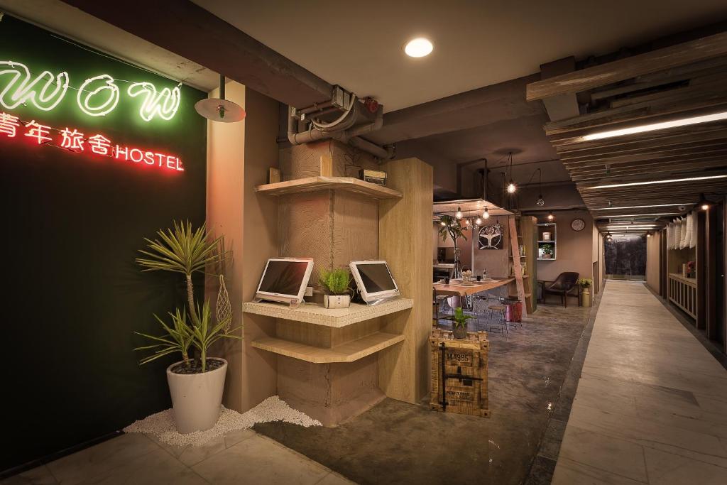 a store with two computers on a shelf in a room at Ximen Wow Hostel in Taipei