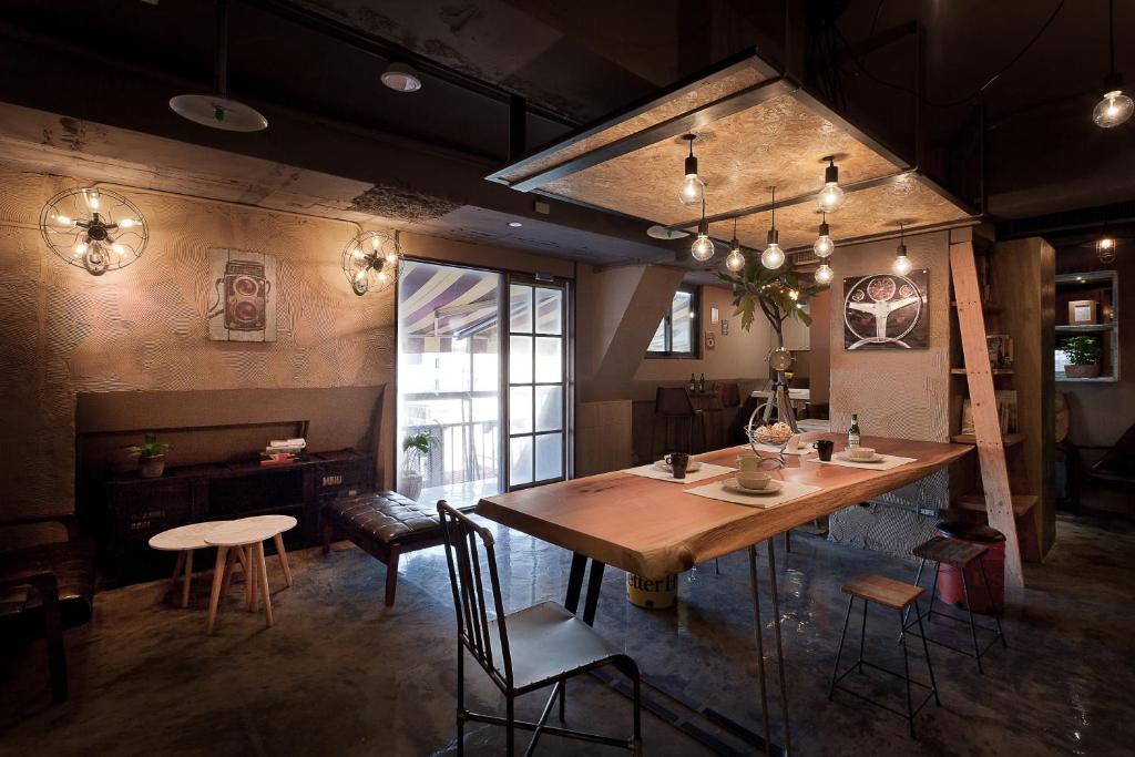 a dining room with a wooden table and chairs at Ximen Wow Hostel in Taipei