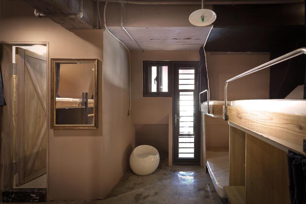 a bathroom with a sink and a mirror at Ximen Wow Hostel in Taipei