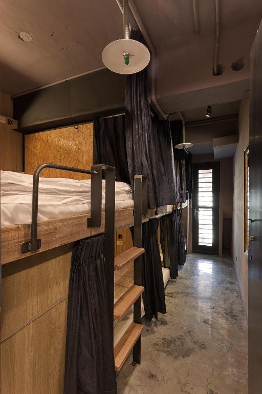 Postel nebo postele na pokoji v ubytování Ximen Wow Hostel