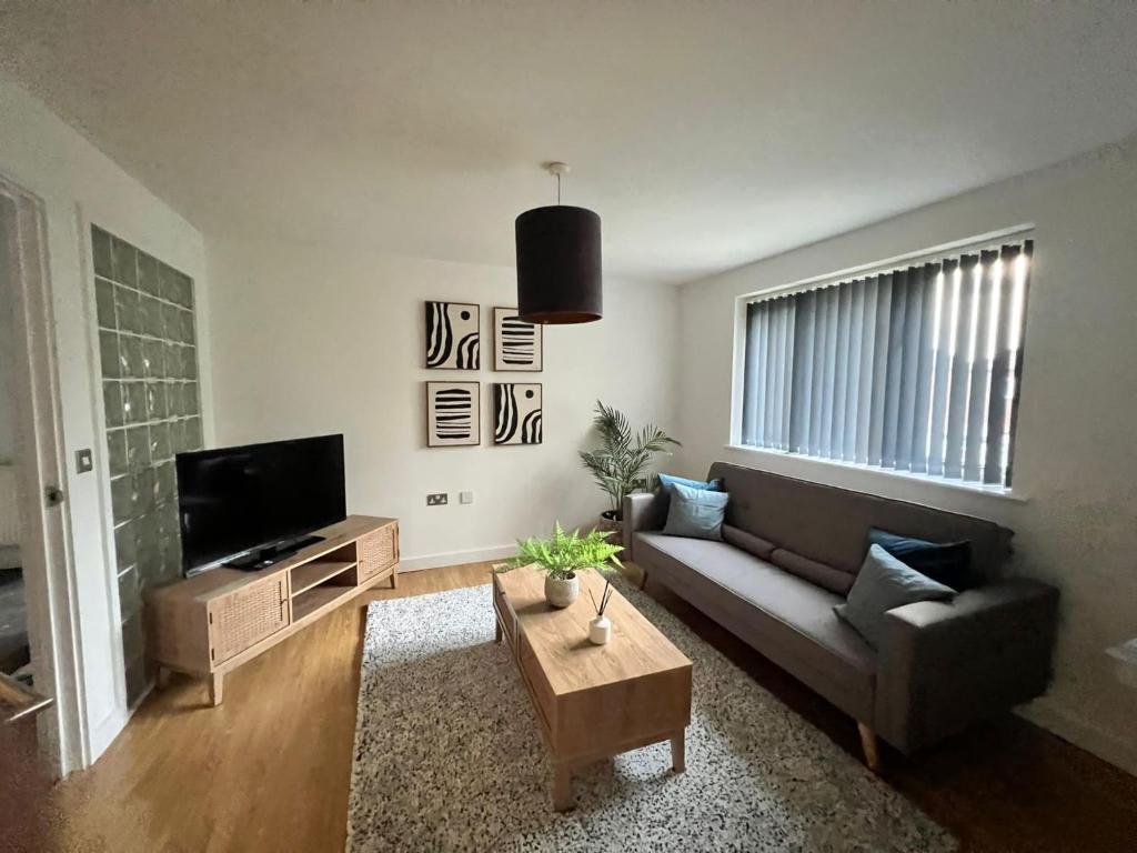 a living room with a couch and a coffee table at Stay Yorkshire 1st floor Hamilton Mews Apartment in Doncaster