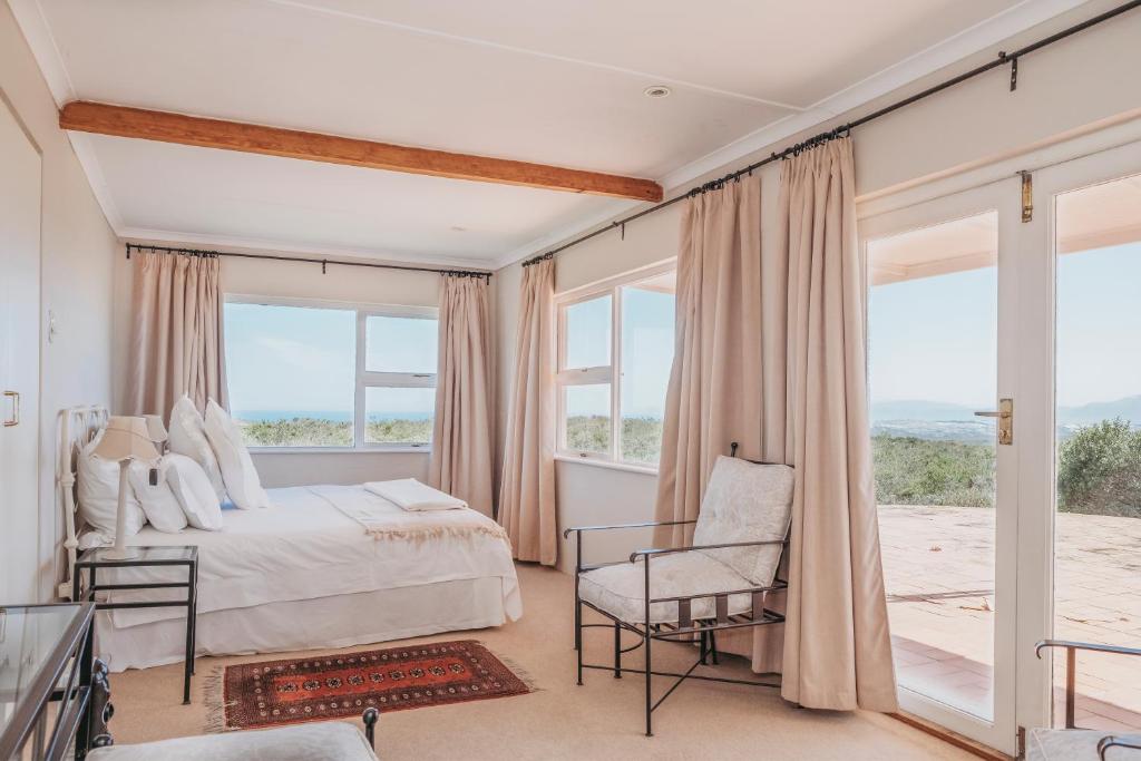 a bedroom with a bed and a window at Fairhill Farm in Gansbaai