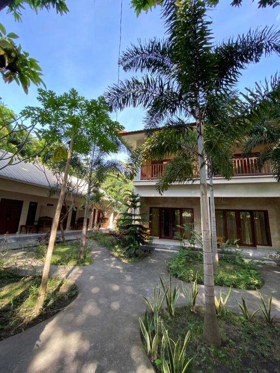 a building with trees in front of it at Follow Your Dreams Gili Air in Gili Islands