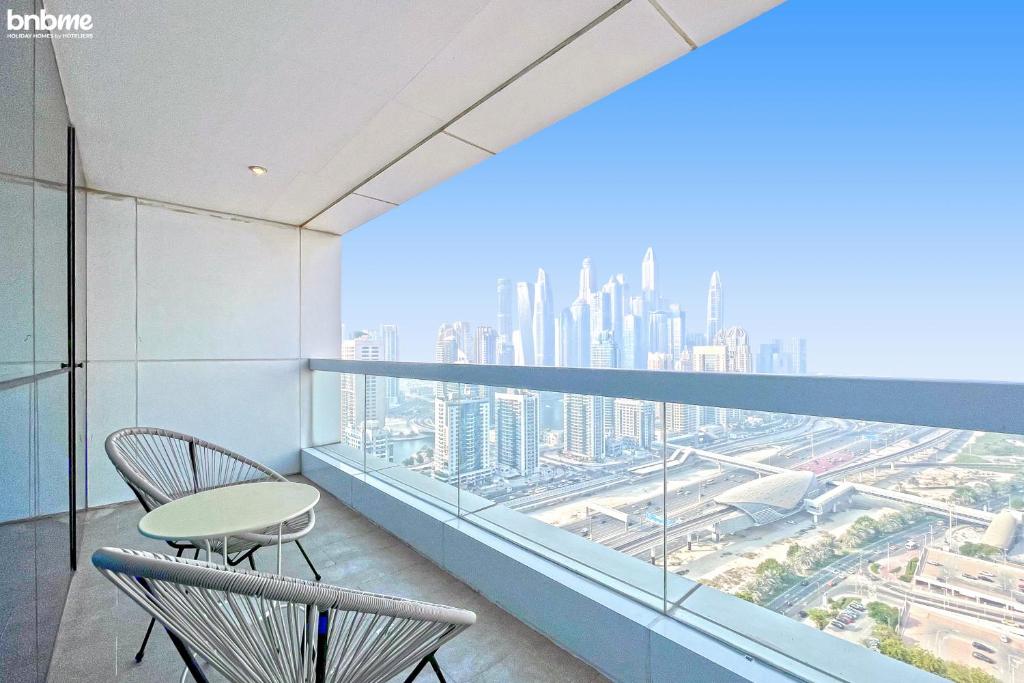a balcony with chairs and a view of the city at bnbmehomes - Live & Work 'w' Style in 1B Apt - 3007 in Dubai