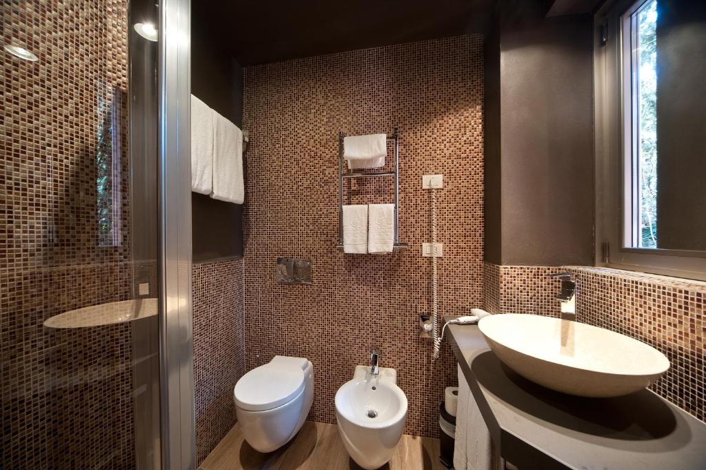 a bathroom with a sink and a toilet at Hotel Carla in Levanto