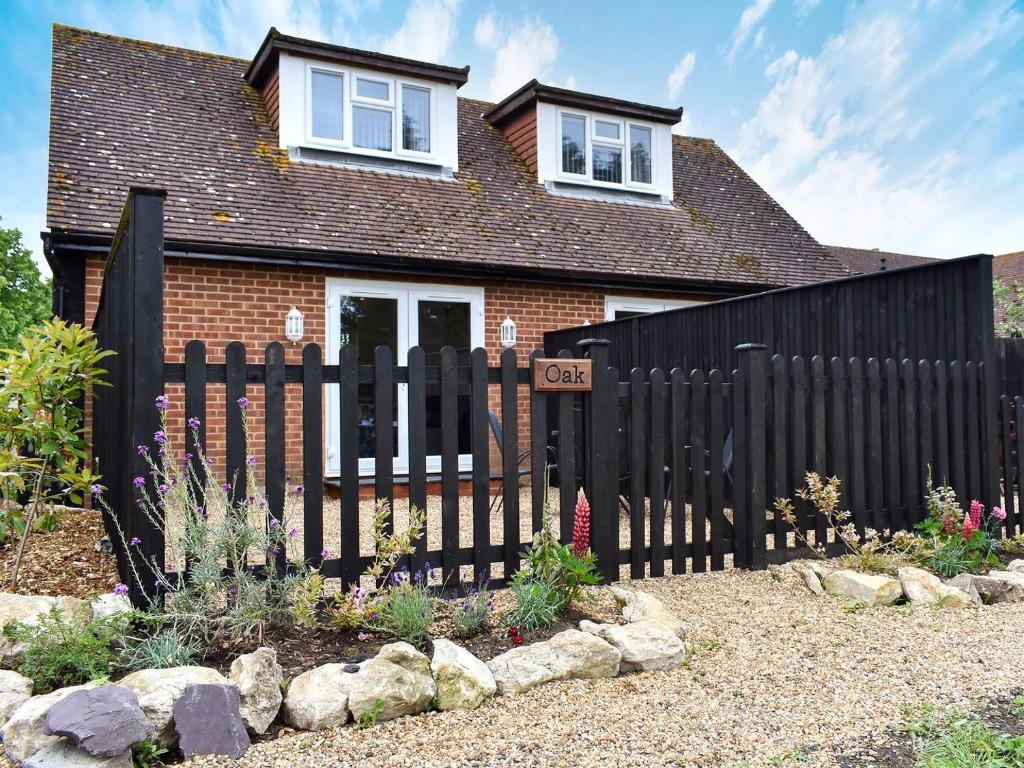 a black fence in front of a house at Oak - Uk11993 in Greenhill