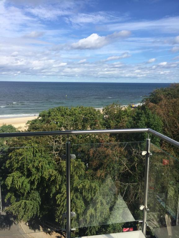 a view of the ocean from the balcony of a condo at Apartament Międzyzdroje z widokiem na morze in Międzyzdroje