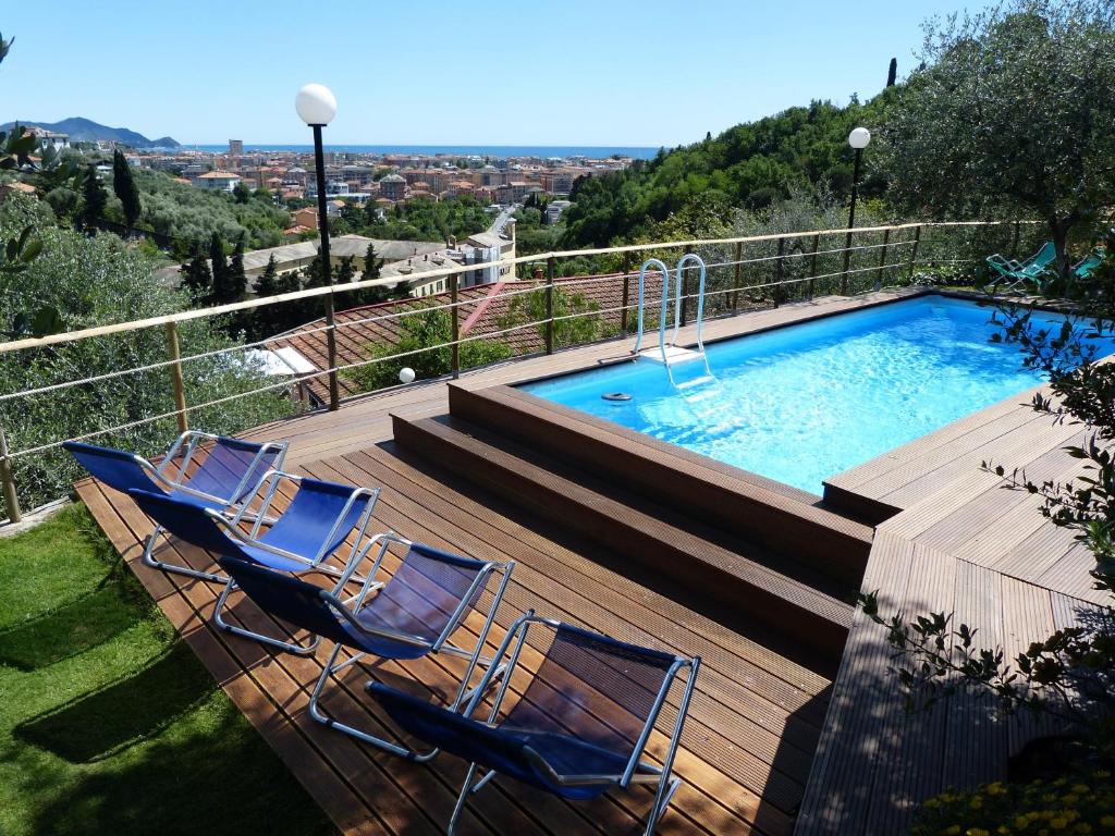 a group of chairs sitting next to a swimming pool at Belvedere Lodge in Chiavari