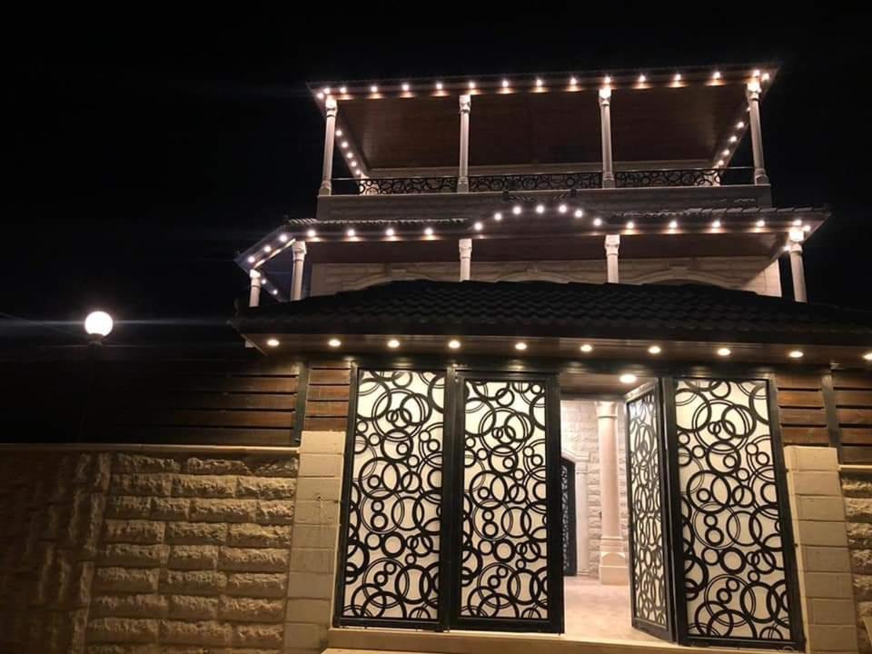 a small house with a gate and lights on it at Old Jericho homestay in Jericho